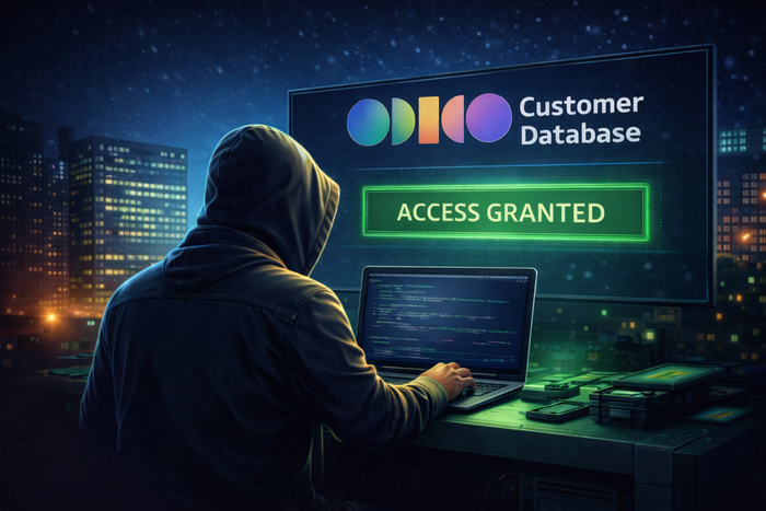 Een hacker achter zijn computer. Op het scherm staat Odido Customer Database, Acces Granted
